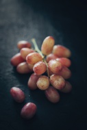 Red grapes on slate