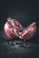 Sliced pomegranate on slate