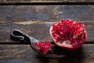 Sliced pomegranate and a knif...