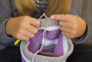 Girl crocheting a cap, close-up