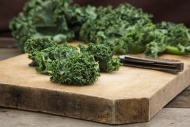 Organic kale on chopping board