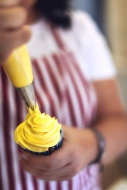 Confectioner making cup cake