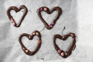 Four chocolate hearts with ro...