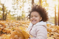 Little girl playing in autumn...