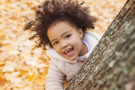 Little girl playing in autumn...