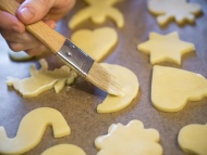 Woman spreading icing on raw ...