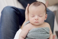 Newborn sleeping in father\'s...