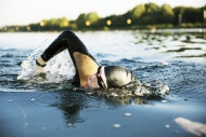 Triathlete swimming in lake