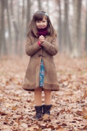 Young girl, brown coat in par...