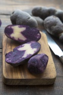 Sliced and whole purple potat...