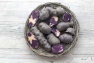 Sliced and whole purple potat...