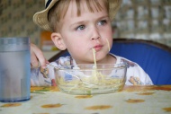 Portrait of little boy eating...