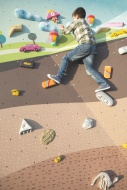 Boy at climbing wall on a pla...