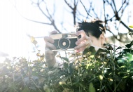 Woman shooting pictures over ...