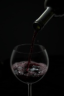Red wine being poured into a ...