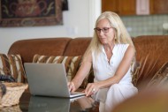 Senior woman sitting on couch...