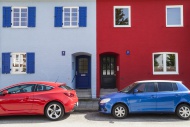 A red and a blue car parking ...