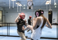 Young woman in gym doing self...