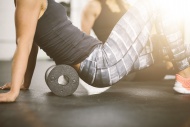 People in gym using foam roller