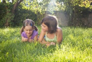 Two girls lying side by side ...