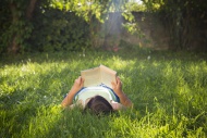 Girl reading book on a meadow