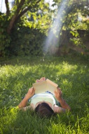 Girl reading book on a meadow