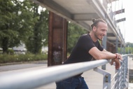 Laughing man leaning on railing