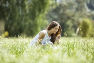 Woman crouching on a meadow s...