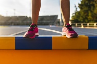 Legs of female athlete standi...