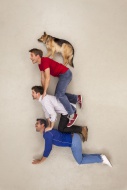 Three friends balancing a dog...