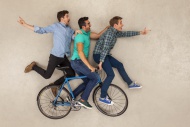 Three friends riding on one b...