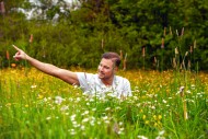 Man sitting in a flower field...