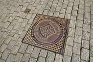 Manhole cover with city coat ...