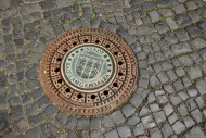 Manhole cover with city coat ...