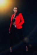 Woman in red blazer standing