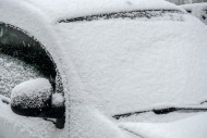 Parked car covered in snow du...