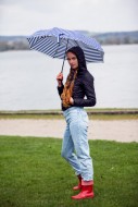 Young woman with umbrella at ...