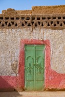 Green iron door in wall of tr...
