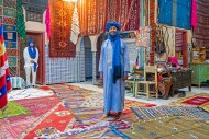 Moroccan vendor selling carpe...