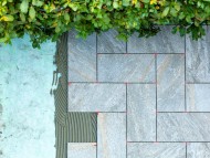 Laying outdoor tiles on a sou...