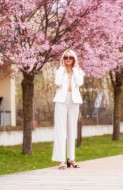 A woman in a white pantsuit s...