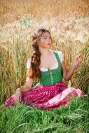 Woman sitting in a cornfield ...