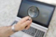 Man Using a Magnifying Glass ...