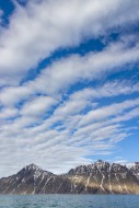 White clouds over mountains a...