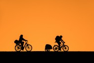 Cycling young couple wearing ...