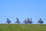 Mother riding on her e-bike /...